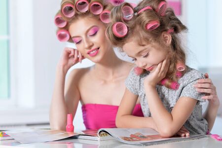 Mother and daughter in hair curlersの写真素材