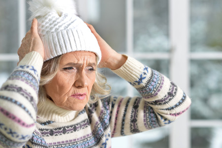 woman in sweater and white hat