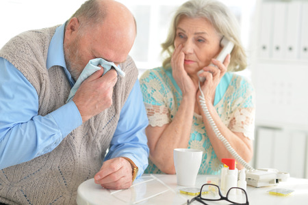 Elderly couple with pillsの写真素材