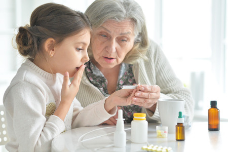 Granddaughter takes care of a sick grandmotherの写真素材