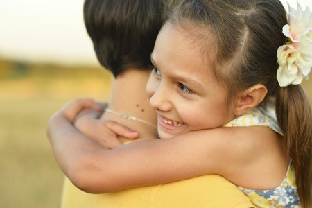 Mother with daughter on wheat fieldの写真素材