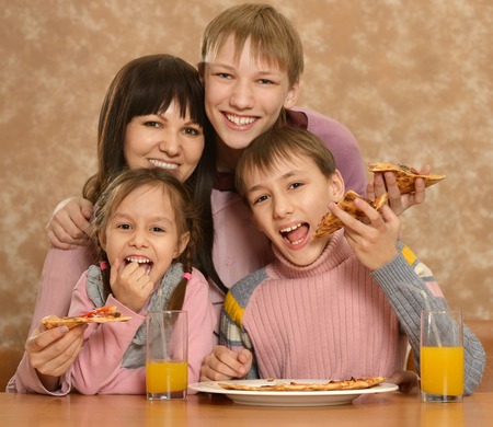 Mother with children eating pizzaの写真素材
