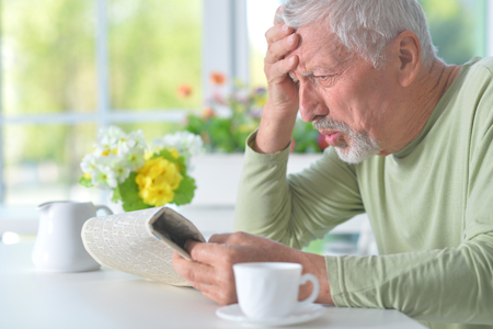 Beautiful old man reading a newspaperの写真素材