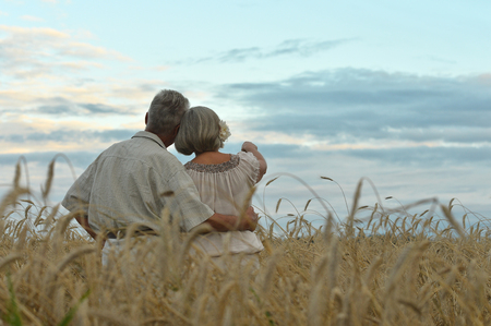 Senior couple on field of wheatの写真素材