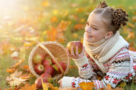 Little girl lying on green grassの写真素材