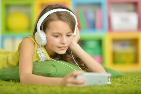 Cute little girl with headphonesの写真素材