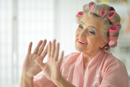 senior woman applying make upの写真素材