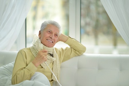 Elder man making inhalation