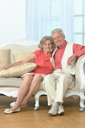 old couple sitting on sofaの写真素材