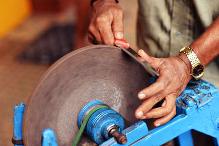 Man grinding knife