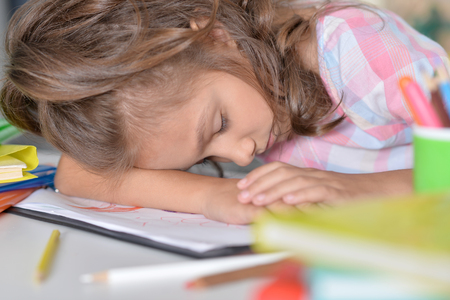 girl sleeping on drawingsの写真素材