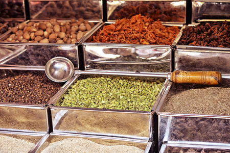 metal boxes with different spices on marketの写真素材