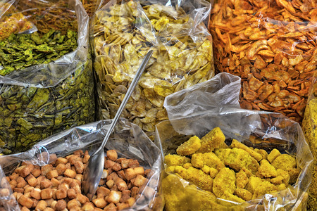 transparent bags with different spices and dries fruits selling on marketの写真素材