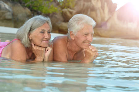 couple resting  at tropical beachの写真素材