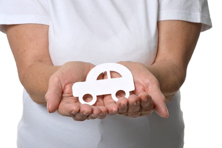 senior woman holing paper model of carの写真素材