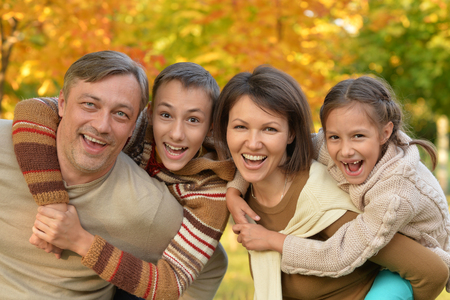 Portrait of happy young family in autumn parkの写真素材