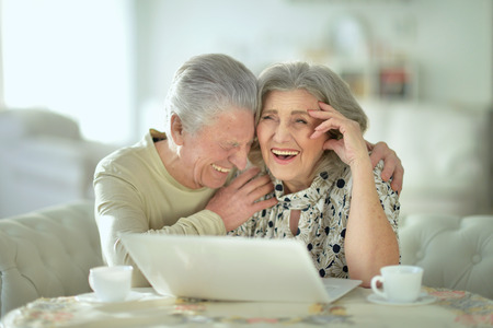 Senior couple  with laptopの写真素材