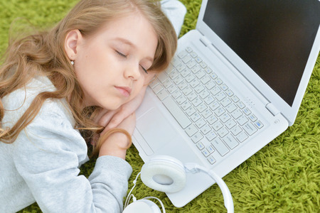 Little girl sleeping on laptop