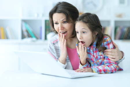 mother and daughter using laptopの写真素材