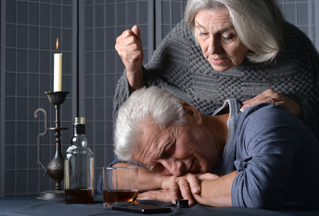 senior man  with bottle of  alcoholの写真素材