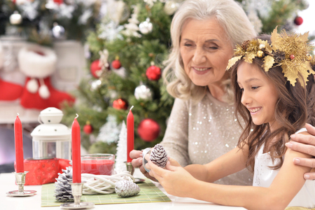 girl with grandmother preparing for Christmasの写真素材