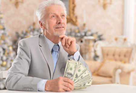 senior businessman counting moneyの写真素材