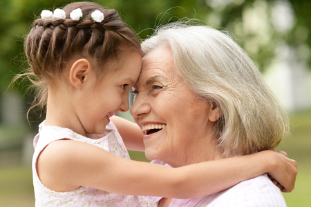 granny and granddaughter posing outdoorsの写真素材