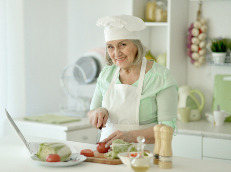 Senior chef woman portrait at kitchenの写真素材