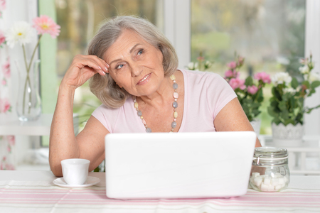 Senior woman working with laptopの写真素材