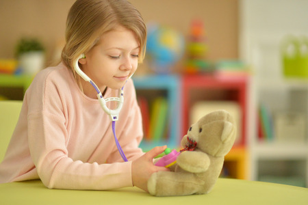 Cute little girl playing nurseの写真素材