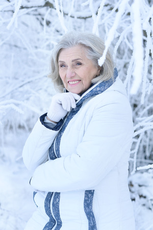 mature woman in winter posing outdoorsの写真素材