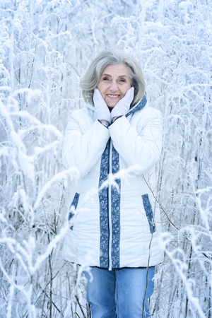 mature woman in winter posing outdoorsの写真素材