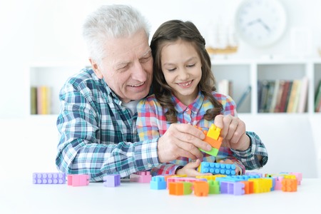 Grandfather  playing with her little granddaughterの写真素材