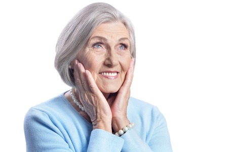 beautiful senior woman posing on white backgroundの写真素材