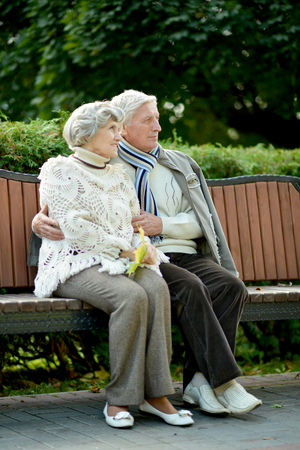 Portrait of happy senior couple in autumn parkの写真素材