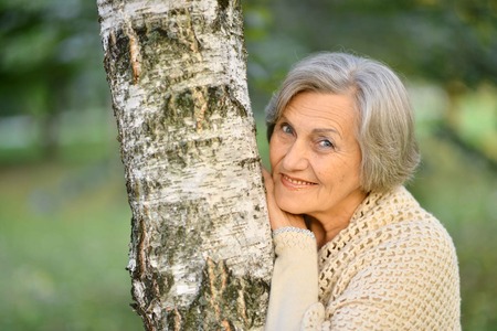 Portrait of senior woman by the treeの写真素材