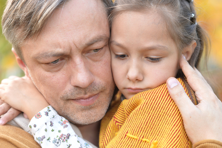 Portrait of father and daughter in parkの写真素材