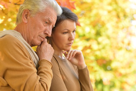 Portrait of Sad woman and senior man huggingの写真素材