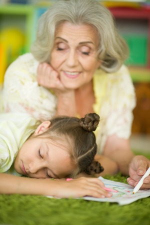 Portrait of grandmother looking at sleeping granddaughterの写真素材
