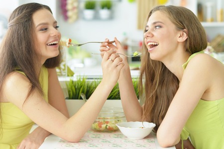 Portrait of young girls in the kitchenの写真素材
