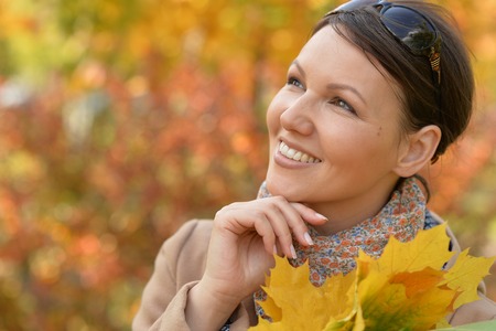 Portrait of beautiful woman in autumn parkの写真素材