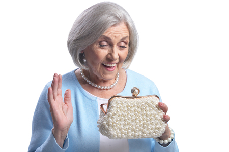 Beautiful senior woman with purse on white backgroundの写真素材