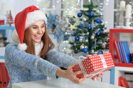 Portrait of smiling woman with Christmas gift