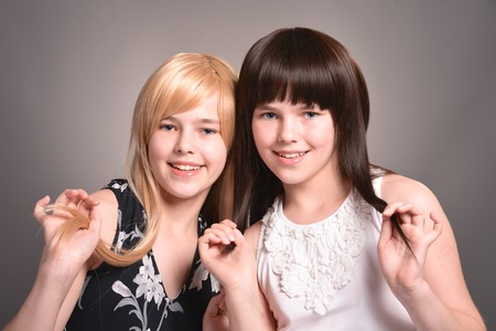 Portrait of two teen girls posing togetherの写真素材