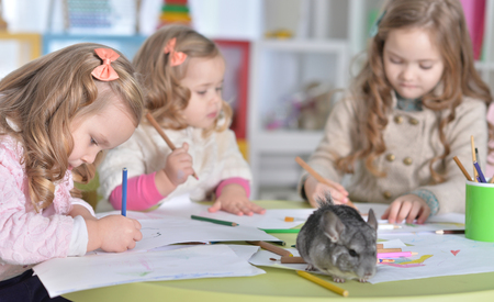 Portrait of a cute little girls drawingの写真素材