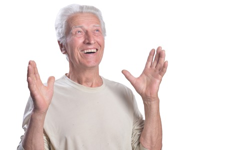 Surprised senior man posing on white background