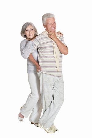 Portrait of beautiful senior couple posing on white backgroundの写真素材