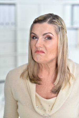Portrait of angry mature woman looking at cameraの写真素材
