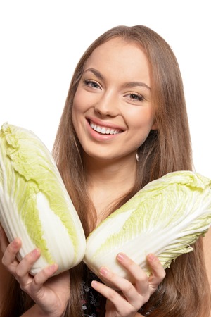 Portrait of beautiful young woman with cabbagesの写真素材