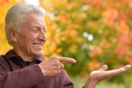 Close up portrait of senior man pointingの写真素材